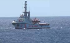 FILE: This grab from a video taken by Local Team shows Spanish humanitarian ship Open Arms arriving off the island of Lampedusa on 15 August 2019 with 147 migrants on board, after a judge in Rome suspended far-right Interior Minister Matteo Salvini's decree banning them from Italy's territorial waters. Picture: AFP.

