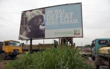 FILE: A photo shows a campaign signboard displayed by the ruling All Progressives Congress (APC) to show its readiness to defeat Boko Haram Islamists on assumption office at Ogijo, Ogun State in southwest Nigeria, on 3 July, 2015. Picture: AFP.