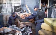 FILE: Residents of a house look on as police search for guns and drugs during a Fiela Operation in Ottery. Picture: Thomas Holder/EWN.