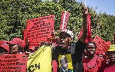 Tripartite alliance supporters hold up placards during a march through Pretoria's CBD in support of Justice Minister Michael Masutha's decision to appeal the parole granted to Chris Hani's killer Janusz Waluś. Picture: Reinart Toerien/EWN.