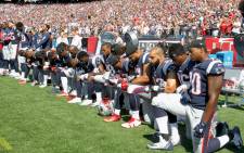 FILE: Members of the New England Patriots kneel during the US national anthem before a game against the Houston Texans at Gillette Stadium on 24 September 2017 in Foxboro, Massachusetts. Picture: AFP.