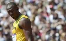 Jamaica's Usain Bolt looks on before competing in the men's 100m heats at the athletics event of the London 2012 Olympic Games on August 4, 2012 in London. Picture: AFP.