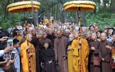 This file photo from 2018 shows Thich Nhat Hanh in a wheelchair arriving with a group of monks at the Tu Hieu Pagoda in Hue. Picture: AFP
