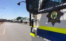 FILE. Police vehicle monitors protesters in Johannesburg. Picture: Vumani Mkhize/EWN