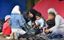 Migrant women with children sit outside their tent, in the park across from The City hall, in Bosnia Sarajevo on 14 May 2018. Picture: AFP.
