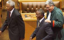 South African President-elect Thabo Mbeki (C) is congratulated 14 June 1999 by the president of the Constitutional Court, Judge Arthur Chaskalson (R), as he leaves the South African Parliament in Cape Town with outgoing President Nelson Mandela (L) after some 400 new deputies elected him president of South Africa in the parliament's afternoon session. Picture: AFP.
