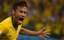Brazil forward Neymar celebrates scoring during a Group A football match between Brazil and Croatia at the Corinthians Arena in Sao Paulo during the 2014 FIFA World Cup on June 12, 2014. Picture: AFP.