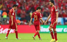 Spain's Diego Costa (L), David Silva (C) and Sergio Busquets look dejected after conceding the second goal in their World Cup match against Chile. Spain lost 2-0. Picture: Facebook.com