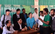 Myanmar Social Welfare Minister Win Myat Aye (lower 2nd L) talks to Rohingya refugees during his visit to the Kutupalong refugee camp in Bangladesh's Ukhia district on 11 April, 2018. Picture: AFP.