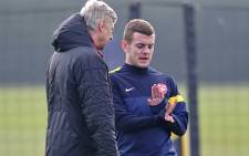 Arsenal manager Arsene Wenger talks to midfielder Jack Wilshere during training session. Picture: AFP