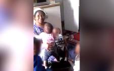 A screengrab of a woman allegedly abusing a baby.