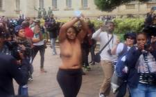 Wits University student goes topless as she pleads with police to cease fire on 4 October, 2016. Picture: Clement Manyathela/EWN.