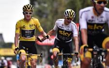 Tour de France winner Great Britain's Geraint Thomas (L) wearing the overall leader's yellow jersey and classification third-placed Great Britain's Christopher Froome (R) react as they cross the finish line, on July 29, 2018.  Picture: AFP