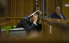 Oscar Pistorius reacts during his murder trial at the High Court in Pretoria on 13 March 2014. Picture: Pool.