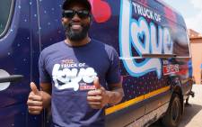 702's Clement Manyathela gives a thumbs up to the station's Truck of Love, with SPAR. Picture: Supplied