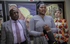 Marriage fraud victim Nomathamsanqa Swartbooi speaks to the media after Home Affairs Minister Aaron Motsoaledi apologizes to her for what happened to her. Advocate Erin-Diane Richards stands next to her. Picture: Abigail Javier/EWN