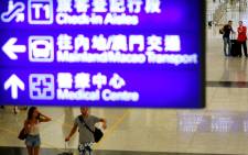 FILE: Passengers walk in the arrivals area after Hong Kong's International airport resumed operations early 13 August 2019. Flights resumed on 13 August at Hong Kong airport a day after a massive pro-democracy rally there forced the shutdown of the busy international transport hub. Picture: AFP.

