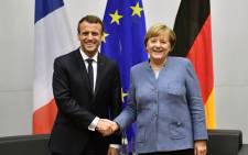 French President Emmanuel Macron (R) shakes hands with German Chancellor Angela Merkel during bilateral talks on the sidelines of the UN conference on climate change (COP23) on 15 November 2017 in Bonn. Picture: AFP