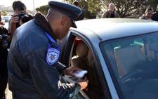 A motorist’s cellphone confiscated on Nelson Mandela Boulevard. Picture: Aletta Gardner/EWN
