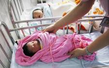 A nurse attending to several newly-born babies at a hospital in Huaibei, east China’s Anhui province. Picture: AFP.