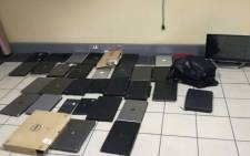 Police in Johannesburg seized laptops and tablets from a man following a tip-off from the community after he was spotted trying to sell them at the East Rand Mall. Picture: @SAPoliceService/Twitter