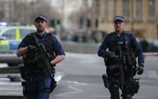 FILE: Armed British police patrol outside the Houses of Parliament in Westminster following a terrorist attack on 22 March, 2017. Picture: AFP