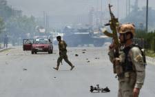 FILE: Afghan security personnel take position at the site of an attack in area of the attack in Kabul. Picture: AFP.