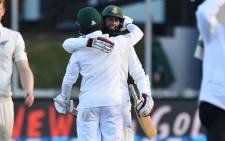 South Africa’s Hashim Amla with teammate Jean-Paul Duminy celebrate after winning the 2nd test during day three of the second Test cricket match between New Zealand and South Africa at the Basin Reserve in Wellington on 18 March, 2017. Picture: AFP.