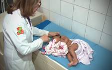 A nurse checks a baby at a US hospital. Picture:Screengrab/CNN