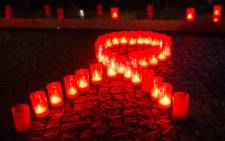 Candles form a red ribbon during World Aids Day. Picture: AFP.