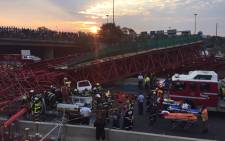 FILE: Paramedics and police at the scene of a collapsed scaffolding of a pedestrian bridge under construction in Sandton on 14 October 2015. The bridge was being built parallel to Grayston Drive over the M1. Picture: Christa Eybers/EWN