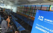 Investors sit watching share prices at an Asia Commercial Bank (ACB)'s securities trading floor in Hanoi on August 22, 2012. Picture: AFP.