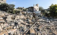 A member of Hamas' military police walks through rubble at a site that was hit by Israeli air strikes in Gaza City on 9 August 2018. Picture: AFP