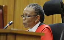 Judge Thokozile Masipa reads her judgment in the murder trial of Oscar Pistorius in Pretoria on 11 September 2014. Picture: Pool.