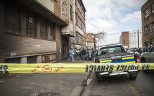 FILE: Forensic pathologists load the bodies of two South African males that were shot dead in a hostel in Jeppestown on 18 April 2015. Picture: Thomas Holder/EWN.