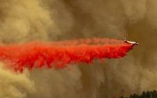 A Coulson 737 firefighting tanker jet drops fire retardant to slow Bobcat Fire at the top of a major run up a mountainside in the Angeles National Forest on 10 September 2020 north of Monrovia, California. Picture: AFP