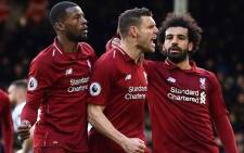 Liverpool's English midfielder James Milner (C) celebrates scoring the team's second goal during the English Premier League football match between Fulham and Liverpool at Craven Cottage in London on 17 March 2019. Picture: AFP 
