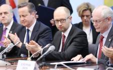 Ukrainian Prime Minister Arseniy Yatsenyuk (2nd-R) meets with EU leaders during the signing of a landmark political cooperation accord on 21 March. Picture:AFP.
