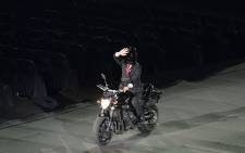 An actor impersonating Indonesian President Joko Widodo waves while riding a motorbike during the opening ceremony of the 2018 Asian Games at the Gelora Bung Karno main stadium in Jakarta on 18 August, 2018. Picture: AFP