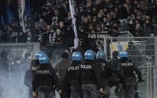 Italian anti-riot policemen stand guard by the curve of Eintracht Frankfurt's fans during the Uefa Europa League group H football match Lazio Rome vs Eintracht Frankfurt on 13 December 2018 at the Olympic stadium in Rome. Picture: AFP