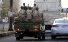 Sudanese security forces ride in the back of a pick up truck through a main avenue in Khartoum as the military continued to disperse protesters by force in Sudan's capital on 4 June 2019.  Picture: AFP