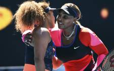 Japan's Naomi Osaka (L) gives a hug to Serena Williams of the US after their women's singles semi-final match on day eleven of the Australian Open tennis tournament in Melbourne on February 18, 2021. Picture: William West / AFP.