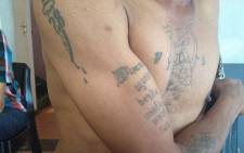 A Cape gang leader shows off his 'chapies' or tattoos. Picture: Giovanna Gerbi/EWN
