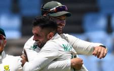 Keshav Maharaj (right) hugs teammate Aiden Markram after taking a hat-trick of wickets against the West Indies in the second Test on 21 June 2021. Picture: @OfficialCSA/Twitter