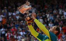 Spain's Rafael Nadal poses with The Musketeers' Cup as he celebrates after victory over Norway's Casper Ruud during their men's singles final match on day fifteen of the Roland-Garros Open tennis tournament at the Court Philippe-Chatrier in Paris on 5 June 2022.