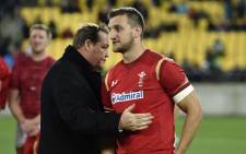 FILE: New Zealand head coach Steve Hansen (L) talks with former Wales captain Sam Warburton (R) after the rugby Test match between the New Zealand All Blacks and Wales in Wellington on 18 June 2016.  Picture: AFP.