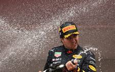 Red Bull Racing's Mexican driver Sergio Perez celebrates with champagne after winning the Monaco Formula 1 Grand Prix at the Monaco street circuit in Monaco, on 29 May 2022. Picture: SEBASTIEN BOZON / AFP