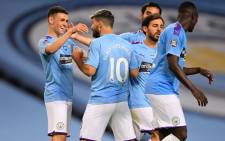 Manchester City midfielder Phil Foden (L) celebrates scoring his team's third goal with striker Sergio Aguero during the English Premier League football match between Manchester City and Arsenal at the Etihad Stadium in Manchester, north west England, on 17 June 2020. Picture: AFP