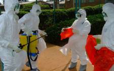 FILE: Officials from the World Health Organisation wear protective clothing on July 28, 2012 as they prepare to enter Kagadi Hospital in Kibale District, about 200 kilometres from Kampala, where an outbreak of Ebola virus started. Picture: AFP.