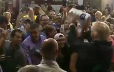 A video screengrab of US President Donald Trump throwing paper towels to a crowd in Puerto Rico.